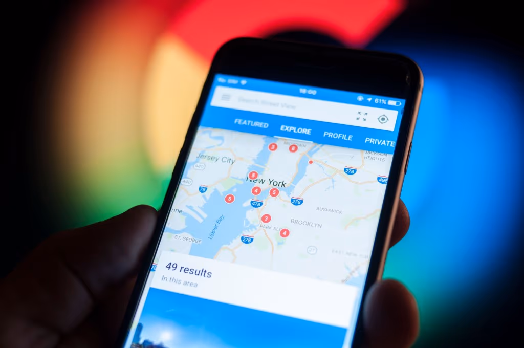 Smartphone showing Google Maps local search results with clustered map pins across a metro area
